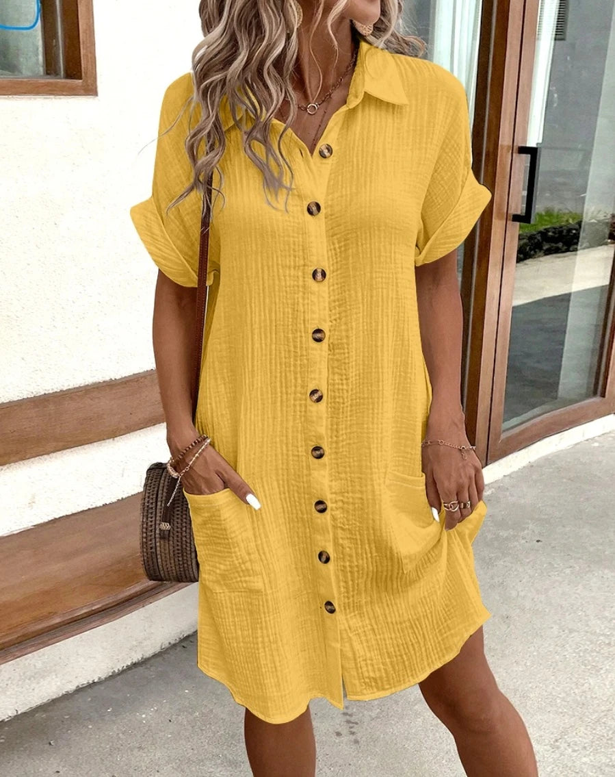Woman wearing vintage V-neck cotton linen mini dress with pockets, knee-length, in a casual summer setting.
