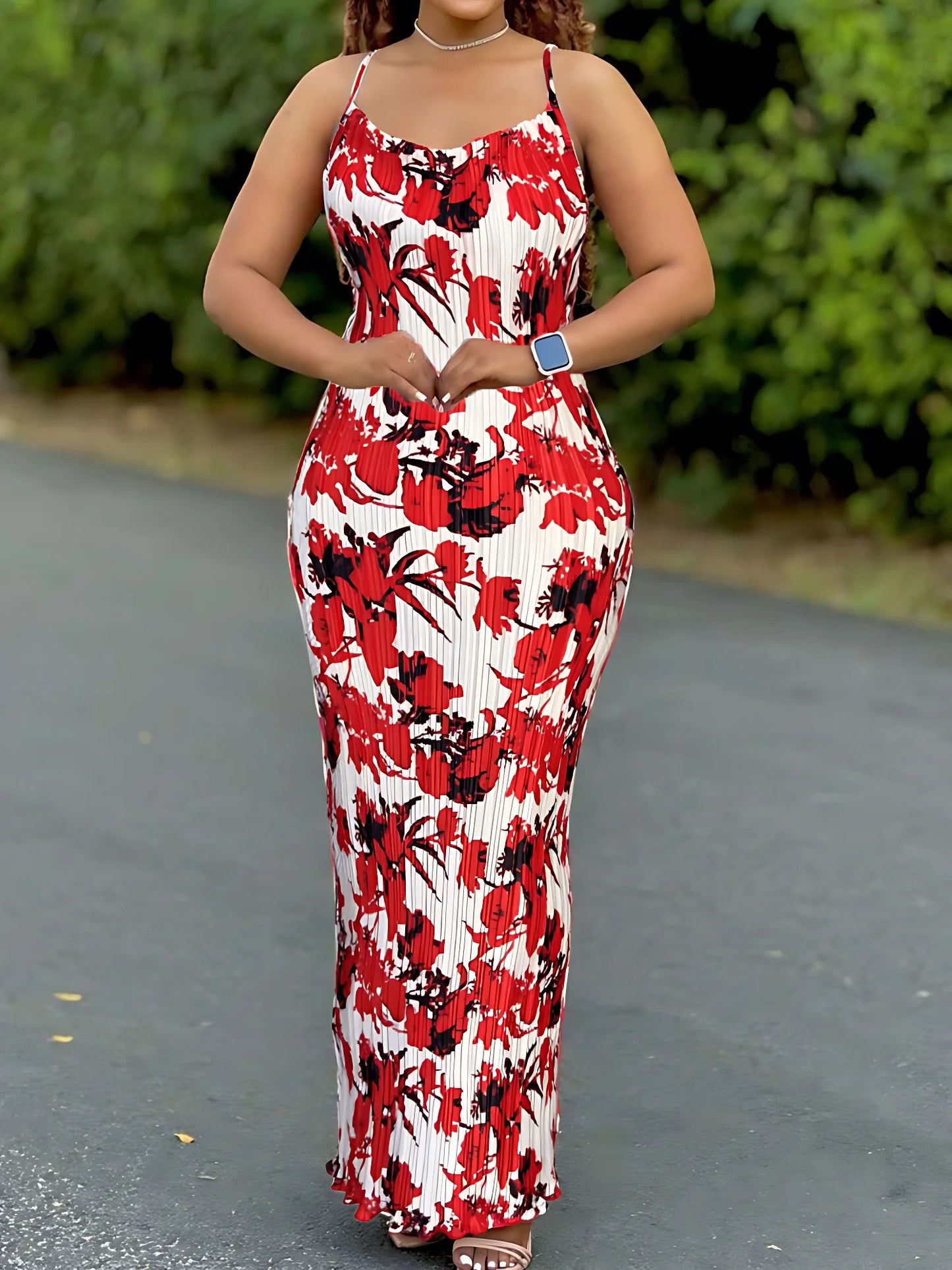 Woman wearing a colorful women's tie-dye spaghetti strap pleated bodycon dress with ankle-length slim fit – perfect for summer or beachwear.