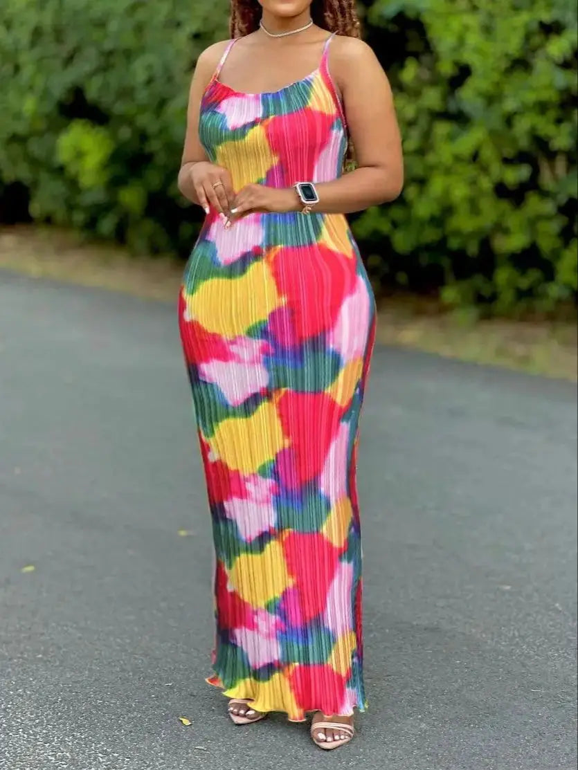 Woman wearing a colorful women's tie-dye spaghetti strap pleated bodycon dress with ankle-length slim fit – perfect for summer or beachwear.