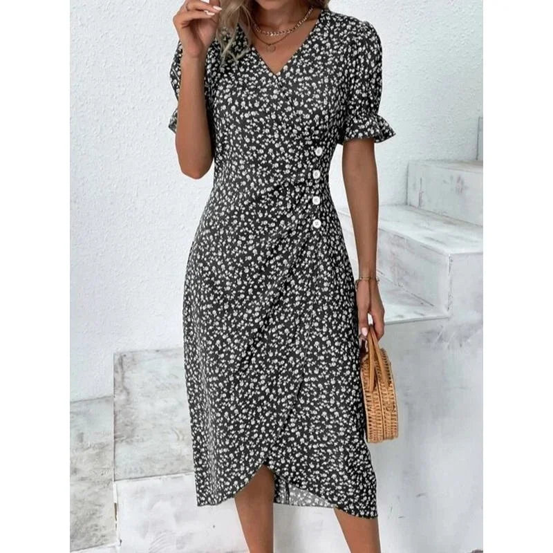 Woman wearing an elegant floral pleated V-neck midi dress with puff sleeves and button details – perfect summer outfit.