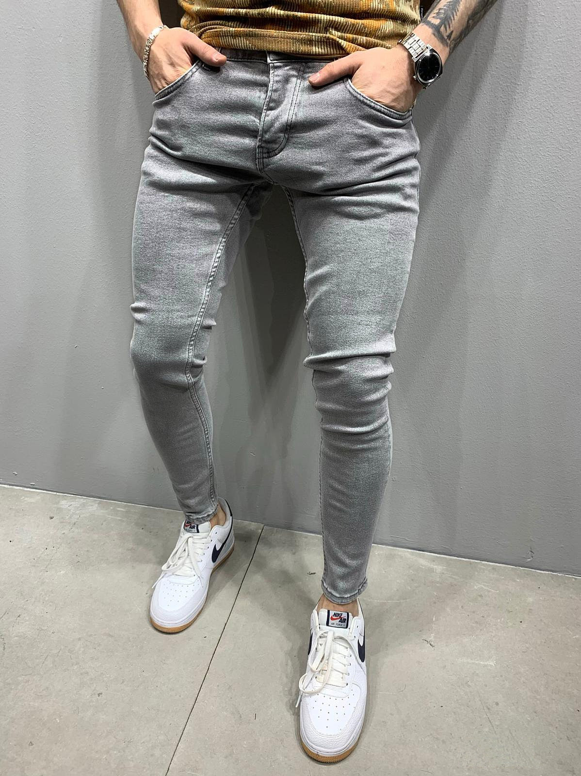 Men's Fashion Street Style Ripped Skinny Jeans with stonewashed and distressed details. Perfect for spring and autumn street style.