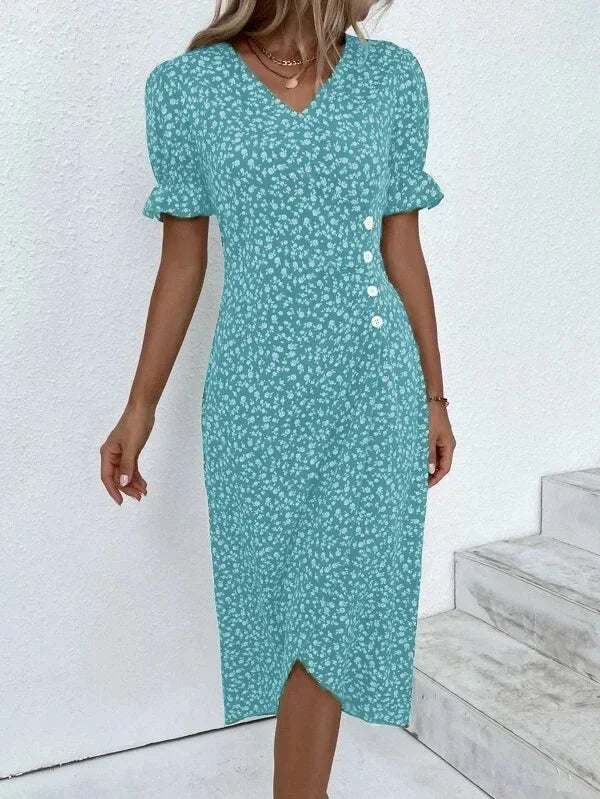 Woman wearing an elegant floral pleated V-neck midi dress with puff sleeves and button details – perfect summer outfit.