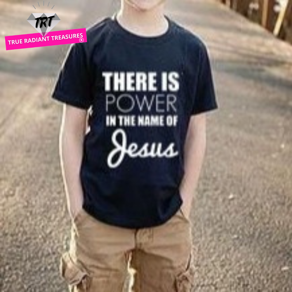 Image of a child wearing True Radiant Treasures' There Is Power In The Name of Jesus Kid's T-Shirt made from 100% polyester. The comfortable and durable t-shirt is perfect for boys and girls alike, with a round neck and short sleeves. Let your child show their religious pride in style with this stylish t-shirt.