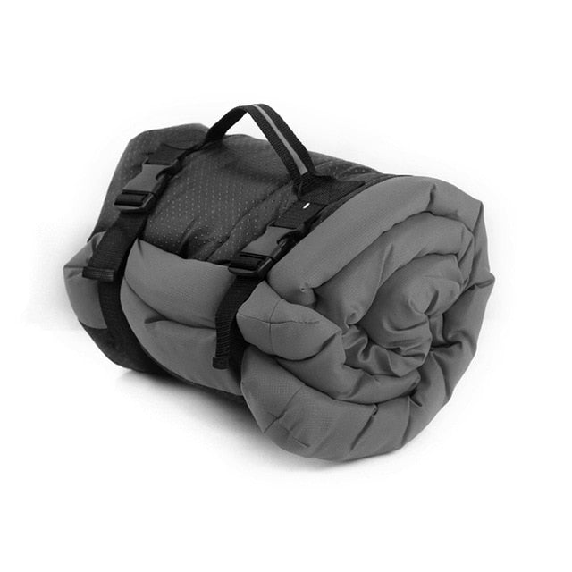 Image of Portable Waterproof Dog Bed - Travel-friendly and durable, ideal for camping, hiking, and road trips. Waterproof microtomic ripstop top with non-slip Rufftex bottom. Easily rolls up for storage with a handle for transport. Available in Medium (27" x 36" x 2") and Large (36" x 48" x 3") sizes. Weighs 2.2 pounds (Medium) and 3.7 pounds (Large). Hand wash or machine wash gentle cycle. Hang dry.