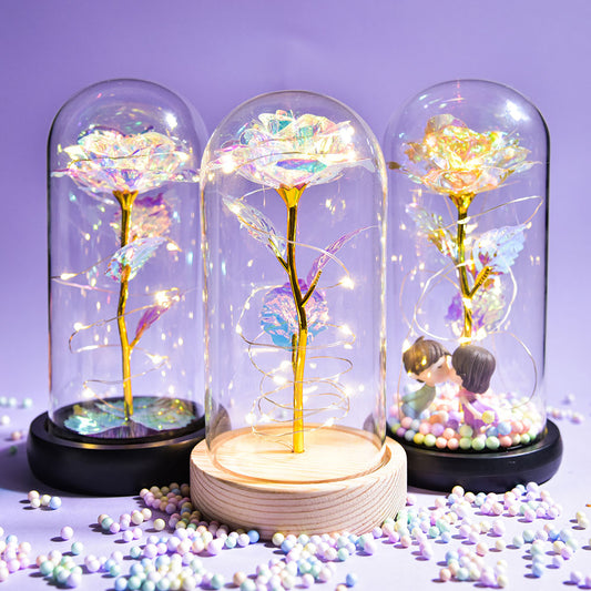 Artificial galaxy rose flowers in glass dome with LED lighting on black wood base, perfect for home decor or romantic gift for Valentine's Day, weddings. or any special occasion.