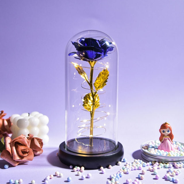 Artificial galaxy rose flowers in glass dome with LED lighting on black wood base, perfect for home decor or romantic gift for Valentine's Day, weddings. or any special occasion.