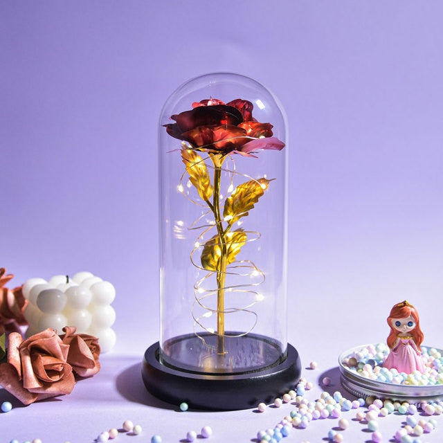Artificial galaxy rose flowers in glass dome with LED lighting on black wood base, perfect for home decor or romantic gift for Valentine's Day, weddings. or any special occasion.