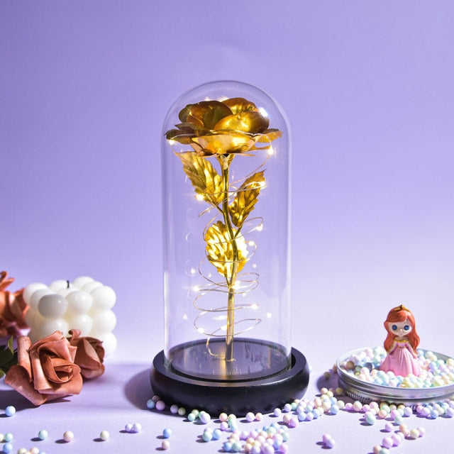 Artificial galaxy rose flowers in glass dome with LED lighting on black wood base, perfect for home decor or romantic gift for Valentine's Day, weddings. or any special occasion.