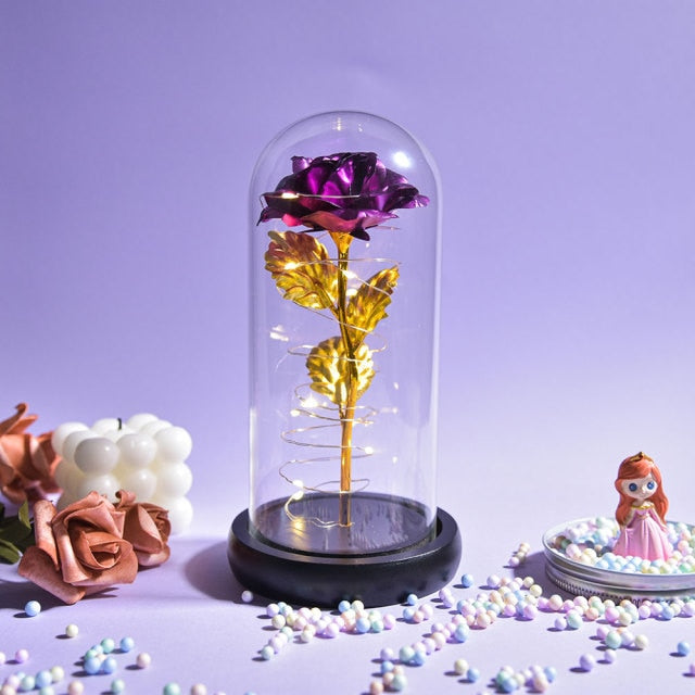 Artificial galaxy rose flowers in glass dome with LED lighting on black wood base, perfect for home decor or romantic gift for Valentine's Day, weddings. or any special occasion.