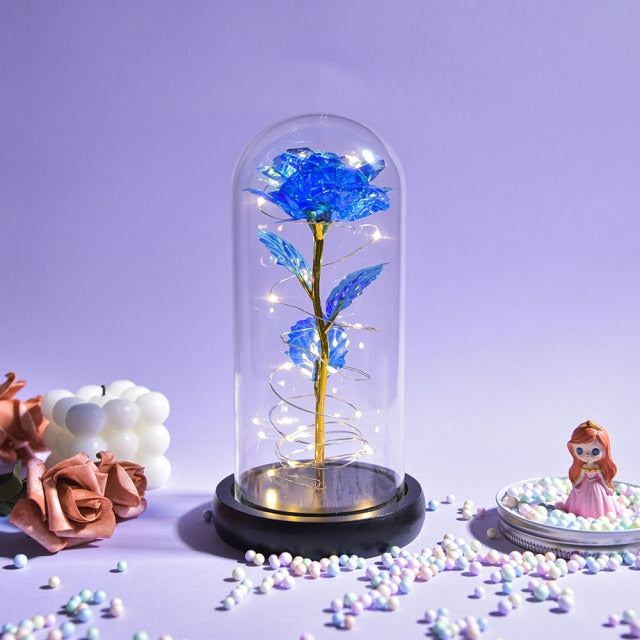 Artificial galaxy rose flowers in glass dome with LED lighting on black wood base, perfect for home decor or romantic gift for Valentine's Day, weddings. or any special occasion.