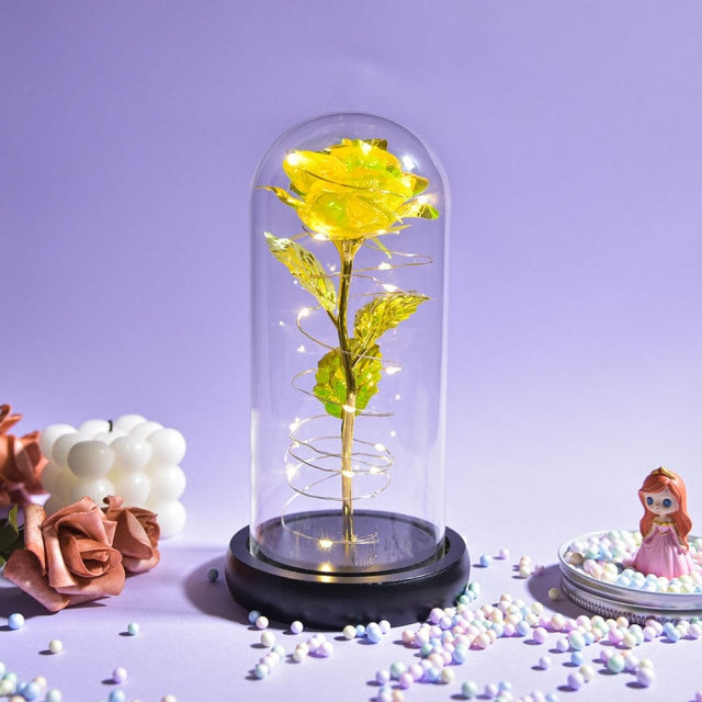 Artificial galaxy rose flowers in glass dome with LED lighting on black wood base, perfect for home decor or romantic gift for Valentine's Day, weddings. or any special occasion.