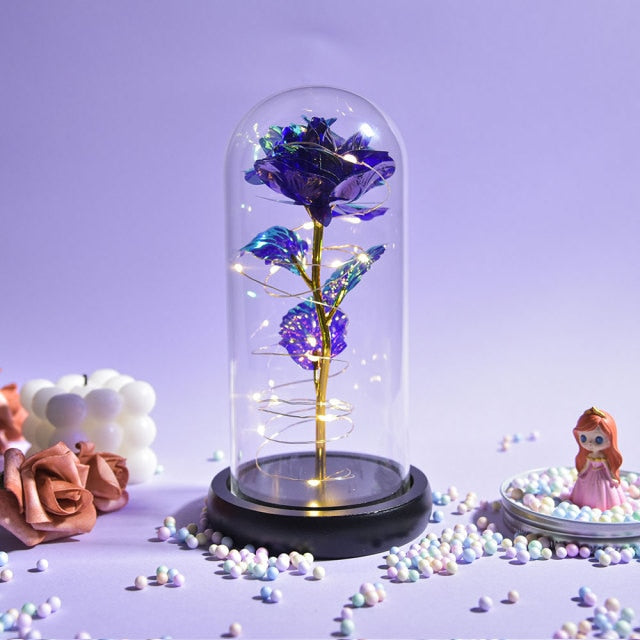 Artificial galaxy rose flowers in glass dome with LED lighting on black wood base, perfect for home decor or romantic gift for Valentine's Day, weddings. or any special occasion.