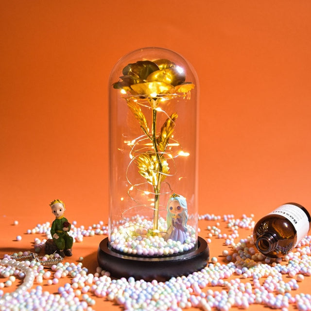 Artificial galaxy rose flowers in glass dome with LED lighting on black wood base, perfect for home decor or romantic gift for Valentine's Day, weddings. or any special occasion.