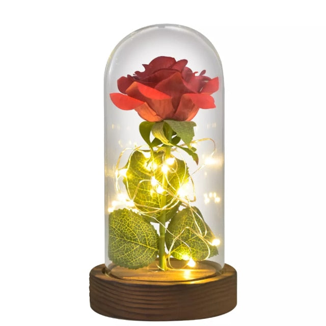 Artificial galaxy rose flowers in glass dome with LED lighting on black wood base, perfect for home decor or romantic gift for Valentine's Day, weddings. or any special occasion.