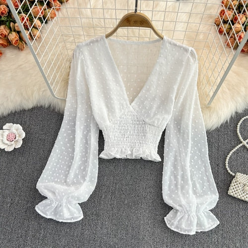 Stylish Long Sleeve Crop Top with polka dot pattern made of silk, cotton, and spandex. Comes with a matching attached tank top for versatile styling.