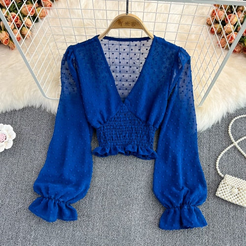 Stylish Long Sleeve Crop Top with polka dot pattern made of silk, cotton, and spandex. Comes with a matching attached tank top for versatile styling.