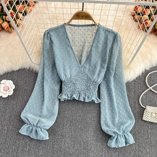 Stylish Long Sleeve Crop Top with polka dot pattern made of silk, cotton, and spandex. Comes with a matching attached tank top for versatile styling.